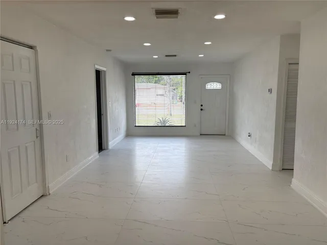 a view of an empty room with a window