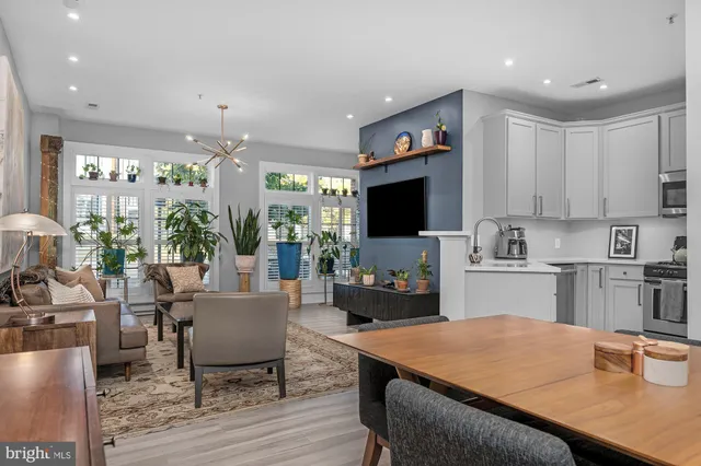 a kitchen with a table chairs microwave and cabinets
