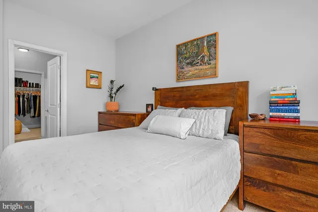 a bedroom with bed and cupboard