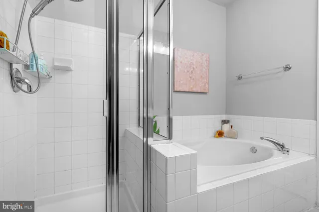 a bathroom with a bathtub and shower