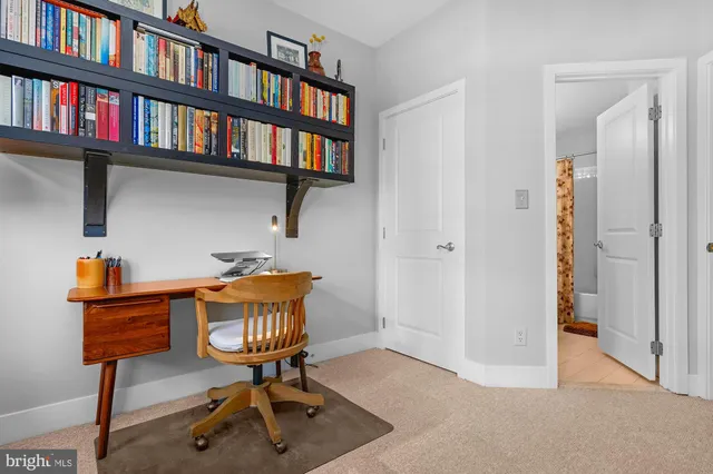 a workspace with furniture bookshelf and a window