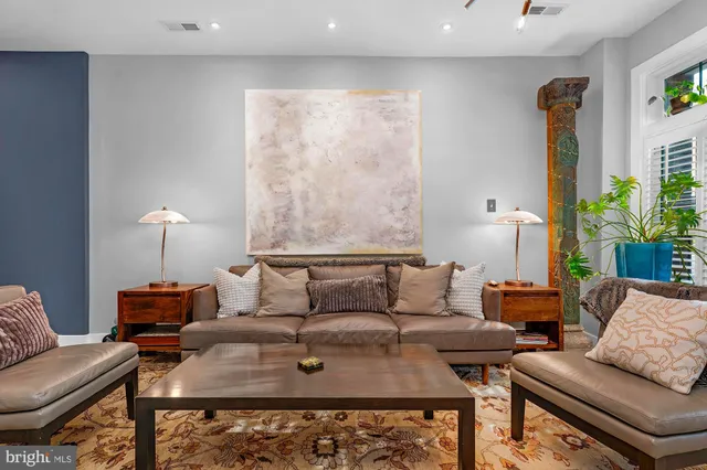 a living room with furniture and a lamp