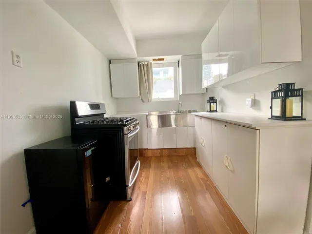 a kitchen with a sink stove and cabinets