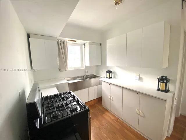 a bathroom with a sink toilet vanity and shower