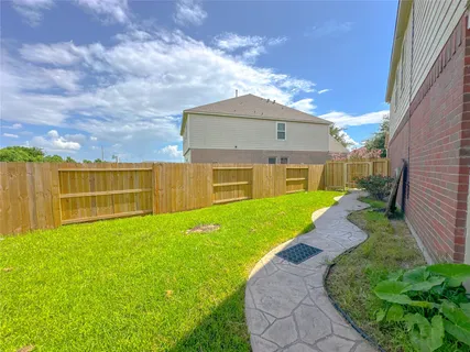a view of a house with a yard and sitting area