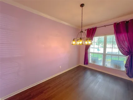 a view of a room with window and wooden floor