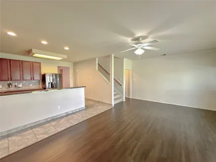 a kitchen with stainless steel appliances granite countertop a sink and a refrigerator