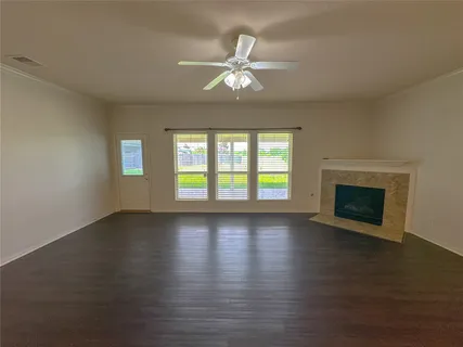 a view of a kitchen with wooden floor and a ceiling fan