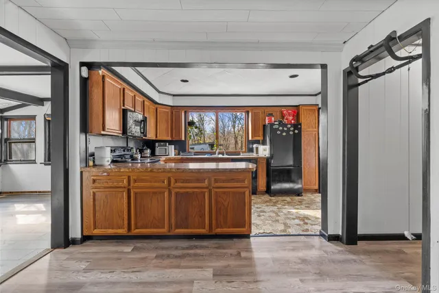 a large kitchen with stainless steel appliances granite countertop a large stove a sink dishwasher and a microwave oven with cabinets