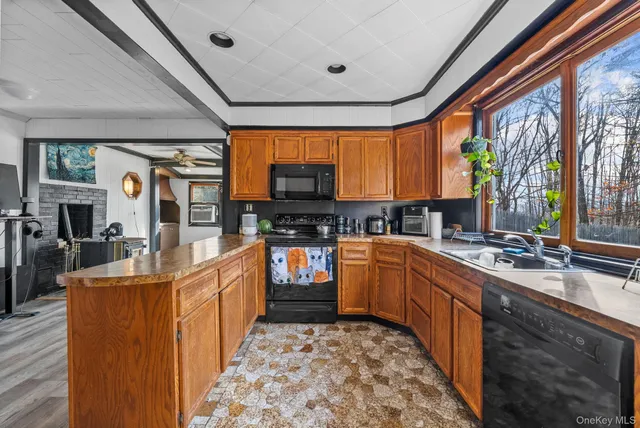 a kitchen with kitchen island granite countertop a refrigerator and a sink