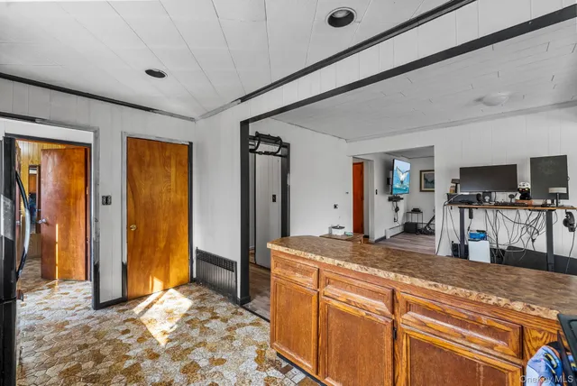 a kitchen with stainless steel appliances granite countertop a stove a sink dishwasher and wooden cabinets with a large window