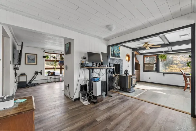 a view of a livingroom with furniture wooden floor and windows