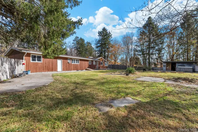 a view of a backyard with swimming pool
