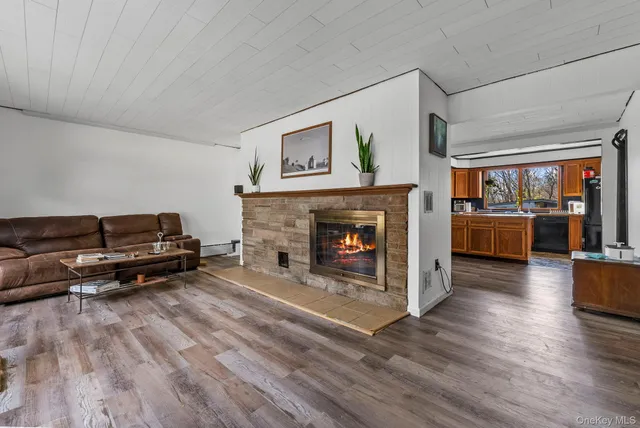 a living room with furniture gym equipment and a flat screen tv