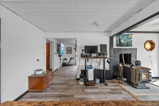 a view of a livingroom with wooden floor and furniture