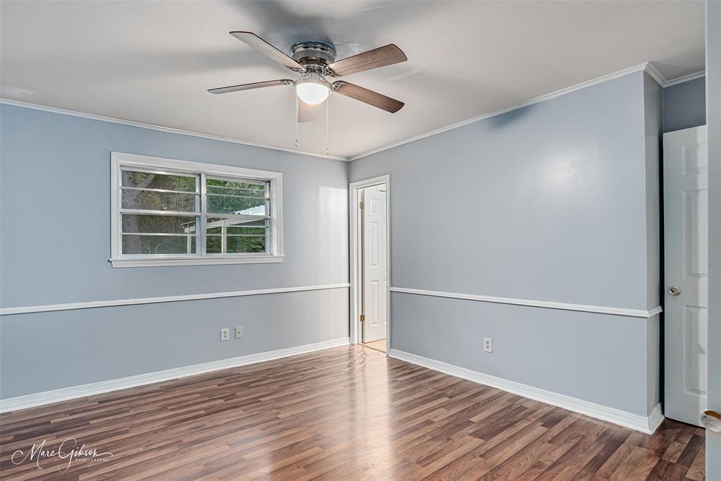 3112 Gorton Road Shreveport, LA 71119 - Photo 17 of 19 an empty room with wooden floor chandelier and windows