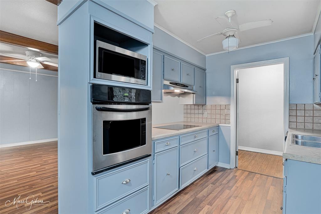 3112 Gorton Road Shreveport, LA 71119 - Photo 8 of 19 a kitchen with granite countertop a stove and a wooden floor