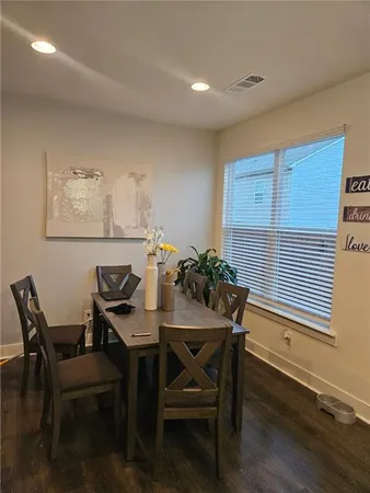 a view of a dining room with furniture and wooden floor