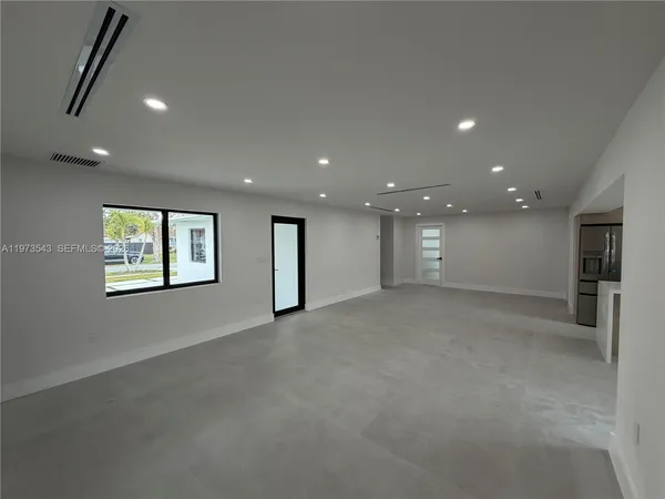 an empty room with windows and closet