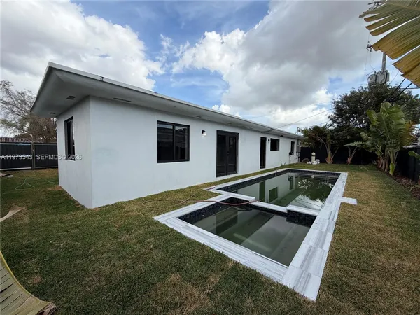 a view of a car park in front of the house