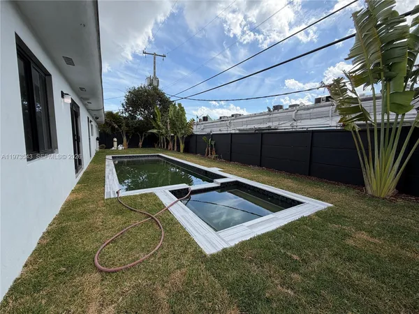 a view of a house with a backyard