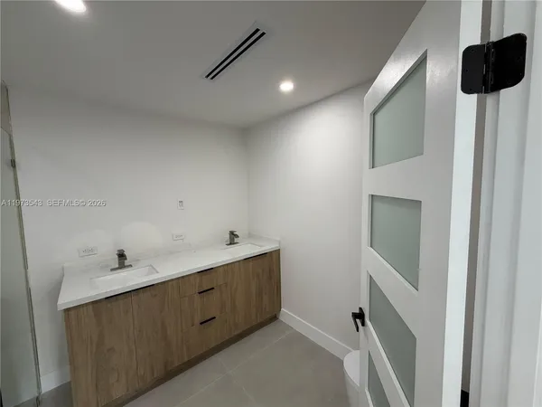 an empty room with windows and entrance