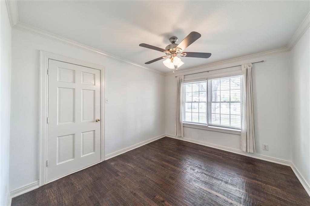 7302 Kenwell Street Dallas, TX 75209 - Photo 11 of 29 a view of an empty room with a window and wooden floor