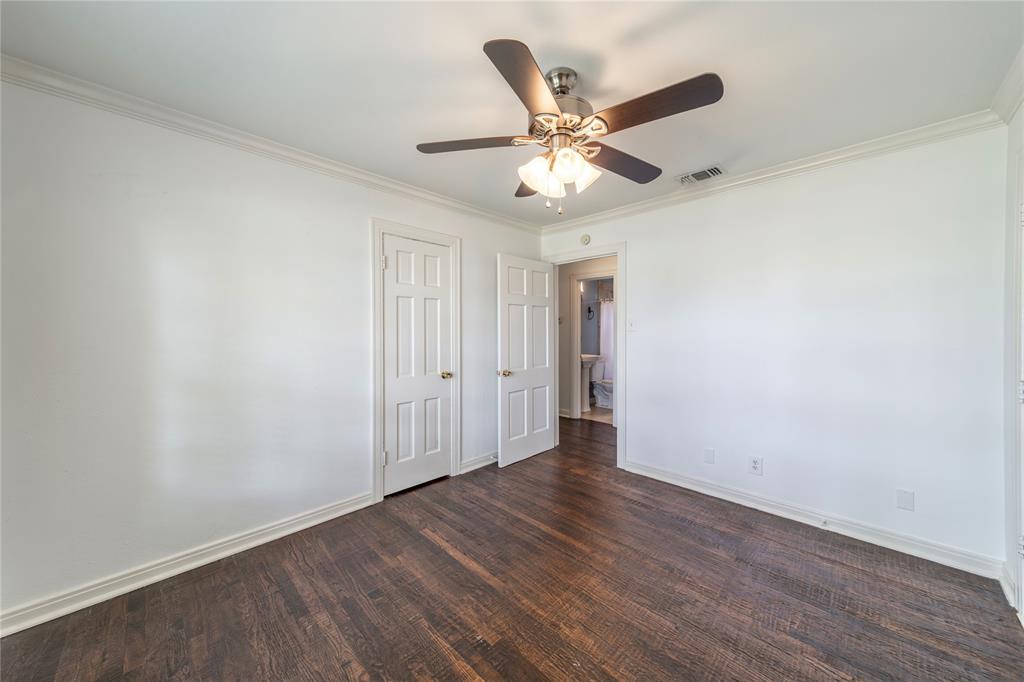 7302 Kenwell Street Dallas, TX 75209 - Photo 12 of 29 an empty room with wooden floor fan and windows