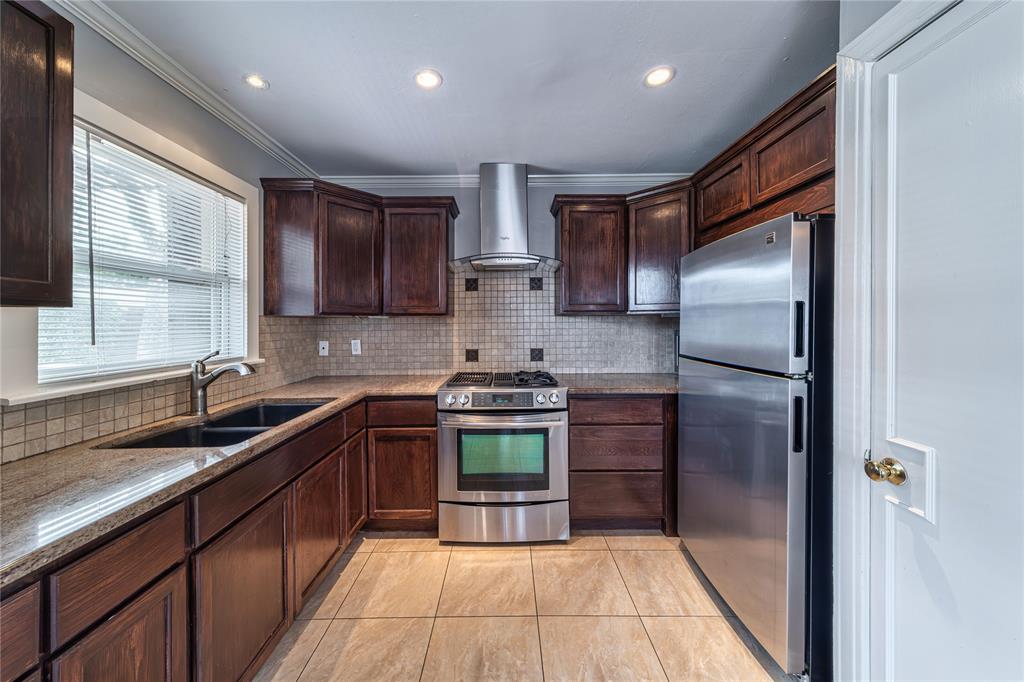 7302 Kenwell Street Dallas, TX 75209 - Photo 5 of 29 a kitchen with stainless steel appliances granite countertop a sink stove and refrigerator