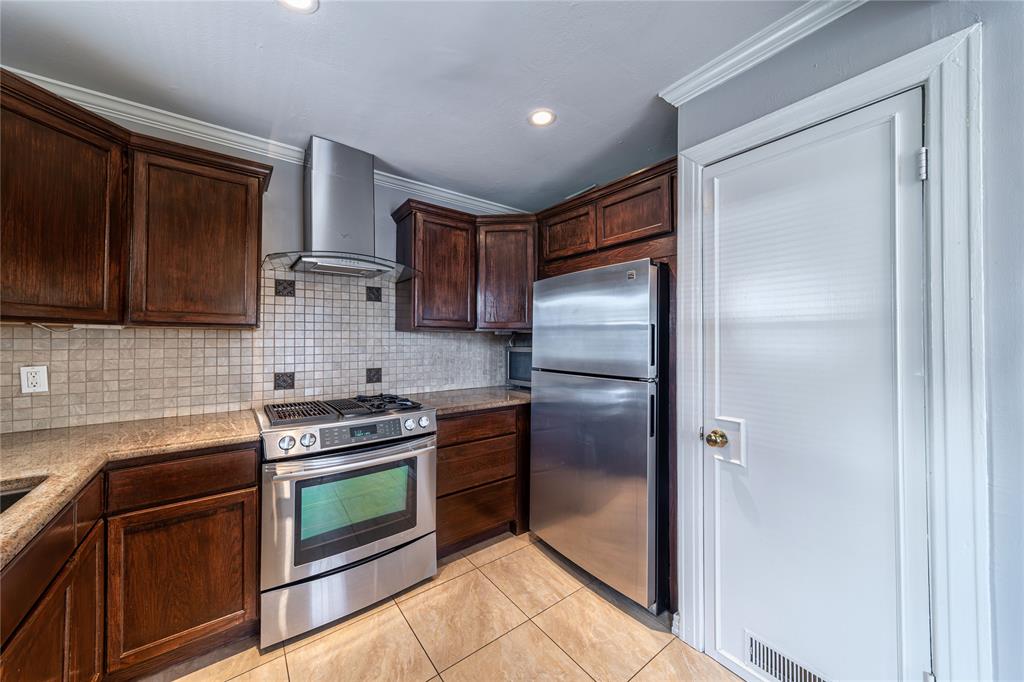 7302 Kenwell Street Dallas, TX 75209 - Photo 6 of 29 a kitchen with a refrigerator stove and microwave