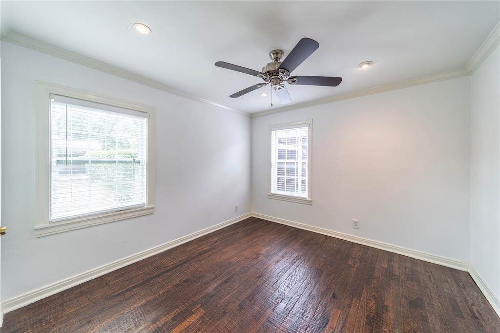 7302 Kenwell Street Dallas, TX 75209 - Photo 9 of 29 a view of an empty room with wooden floor and a window