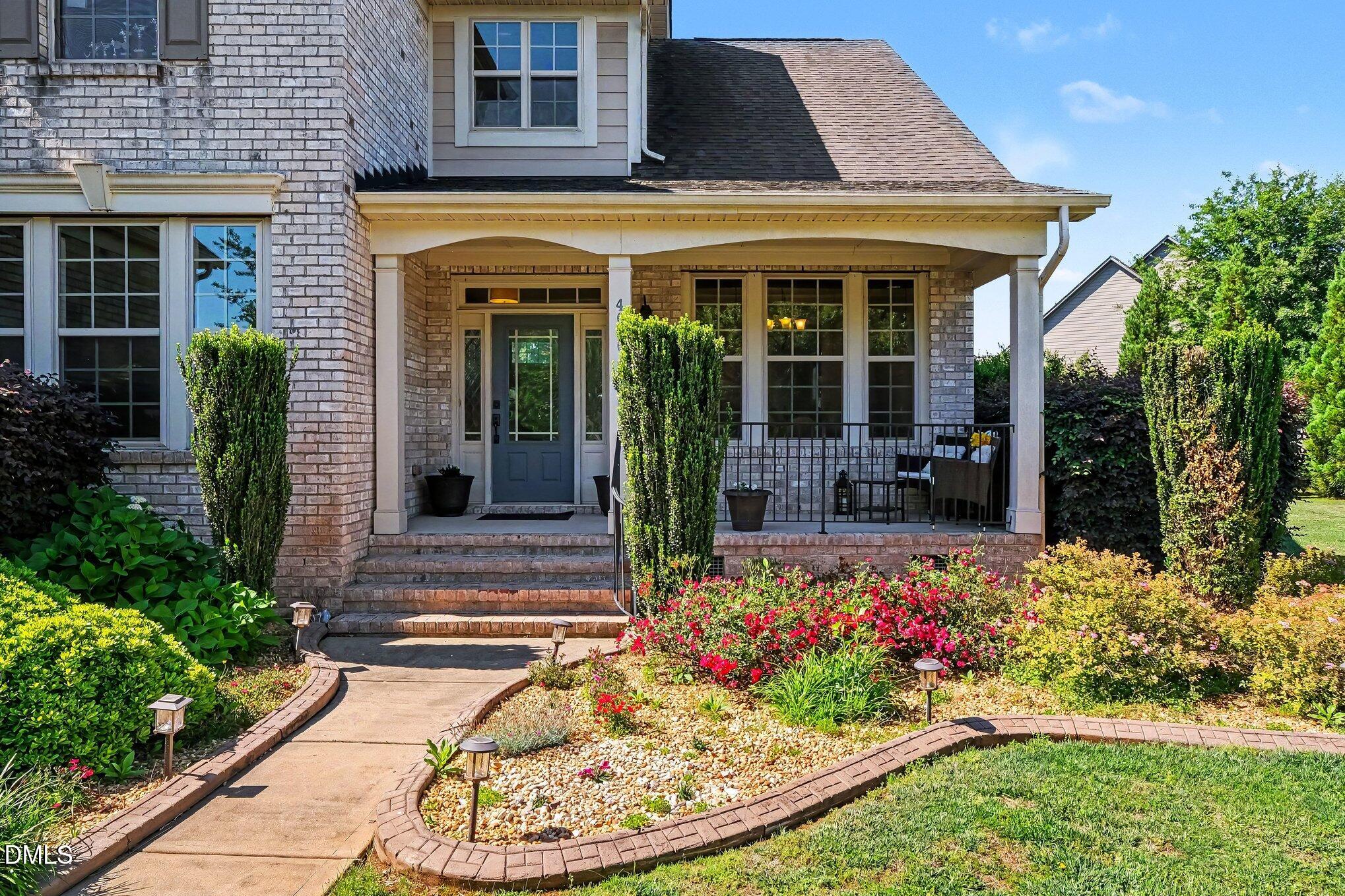 4000 Banks Stone Drive Raleigh, NC 27603 - Photo 6 of 60 a front view of a house with a garden