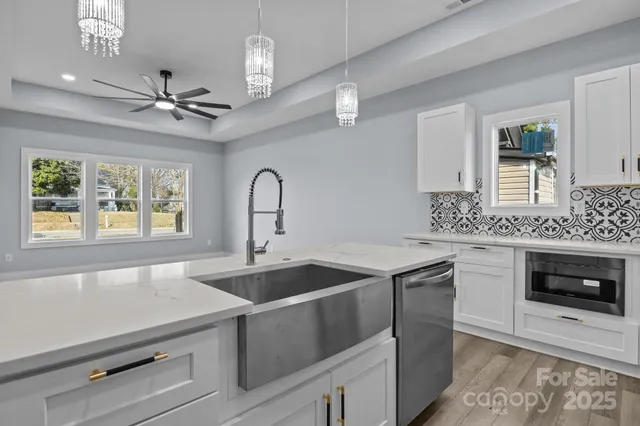 a kitchen with a sink appliances and a window