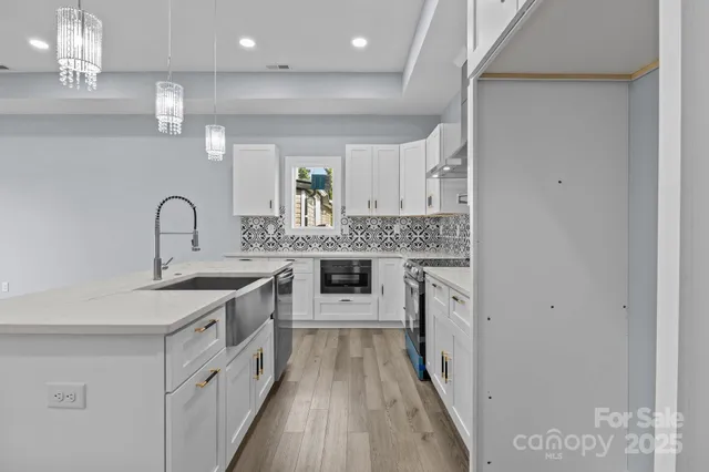a kitchen with stainless steel appliances granite countertop a sink and stove