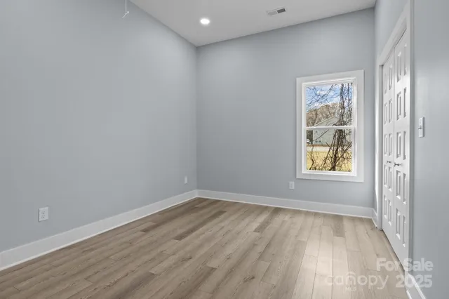a view of room with window and hardwood floor