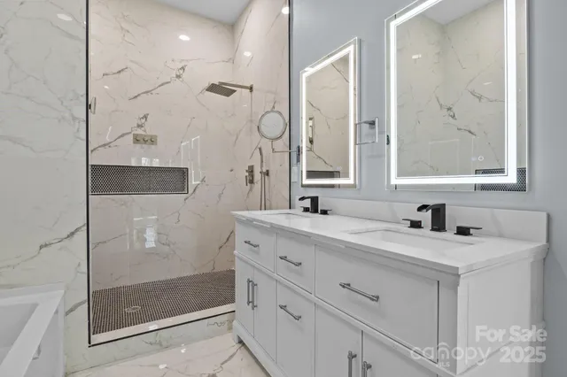 a bathroom with a shower sink and mirror