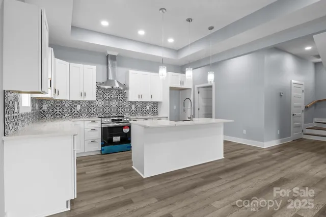 a kitchen with a white cabinets and counter top space