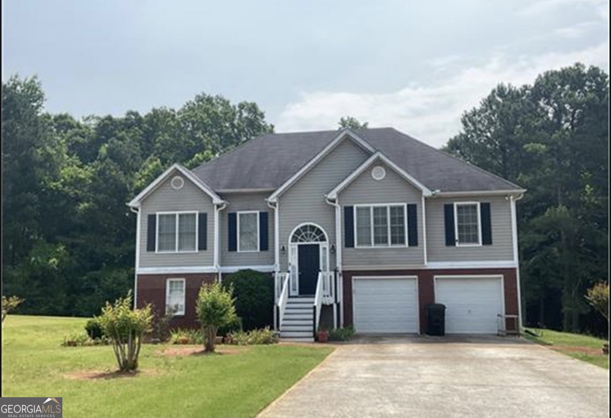 4951 Martin Farms Road Powder Springs, GA 30127 - Photo 1 of 9 a front view of a house with garden
