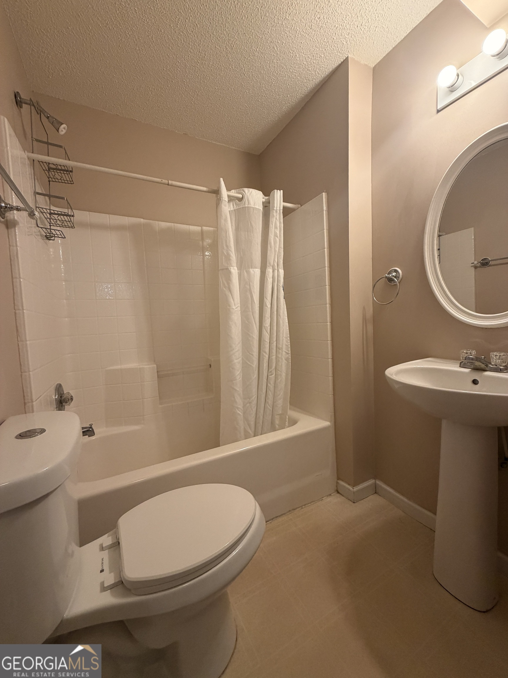 4951 Martin Farms Road Powder Springs, GA 30127 - Photo 3 of 9 a bathroom with a toilet sink and shower