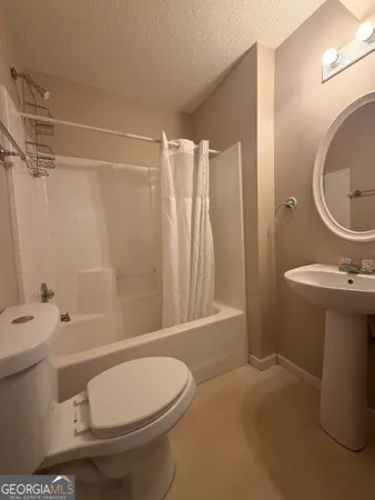 a bathroom with a toilet sink and shower