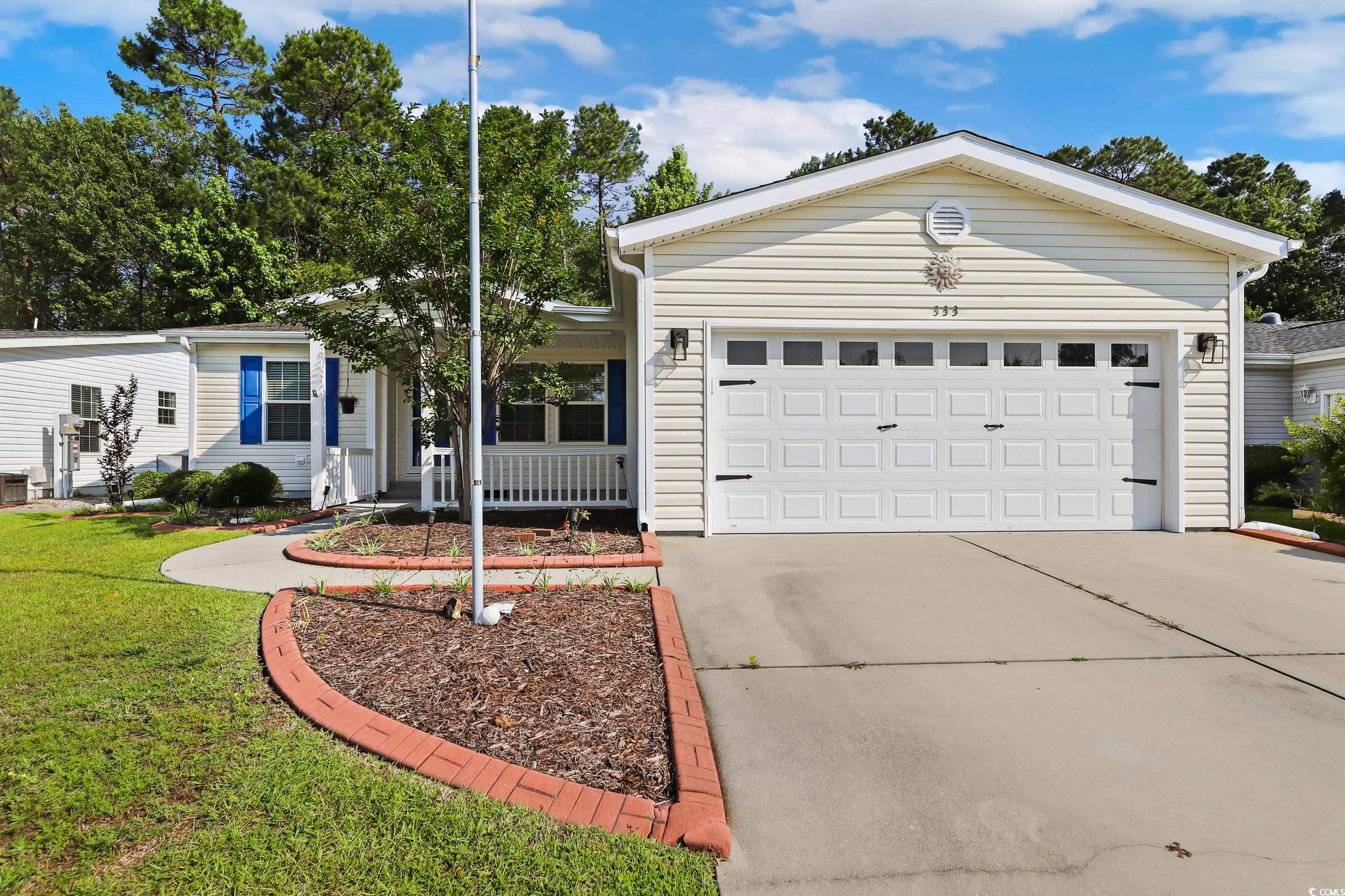 Ranch-style home featuring a front yard, driveway,