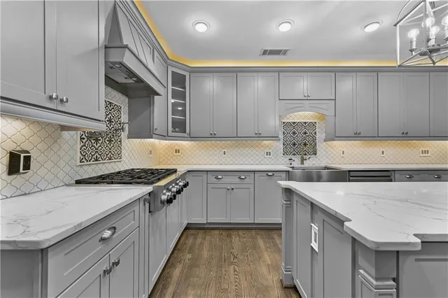 a kitchen with granite countertop a sink stove and cabinets