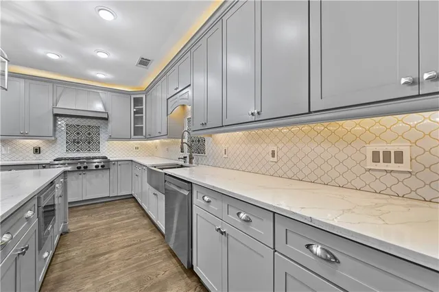 a kitchen with kitchen island granite countertop wooden cabinets and white appliances