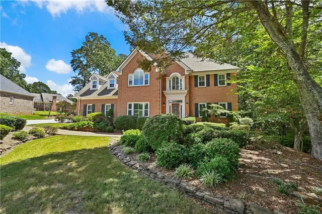 a front view of a house with a yard