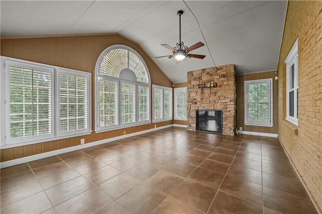 a view of an empty room with a fireplace and a window
