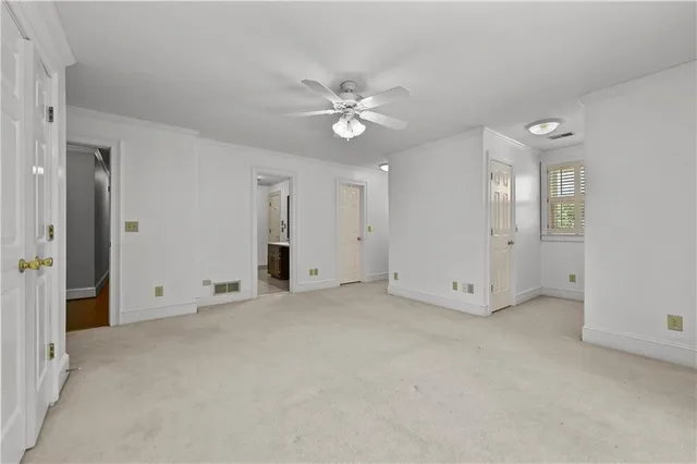 an empty room with fan and entrance