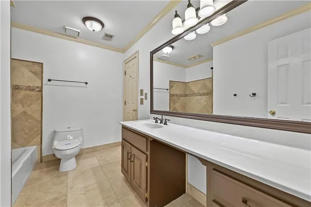 a spacious bathroom with a double vanity sink toilet and a mirror