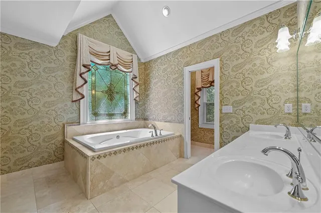 an empty room with a window and a ceiling fan