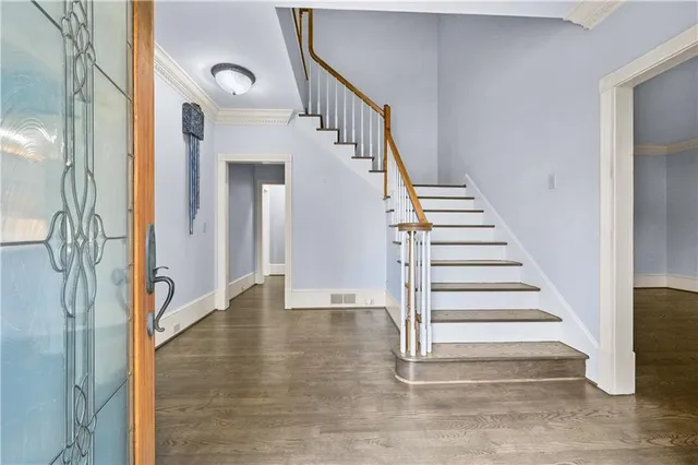 a view of entryway and hall with wooden floor