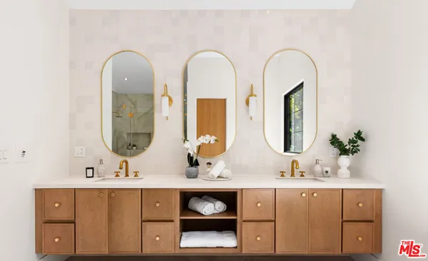 a bathroom with a sink a vanity and a mirror